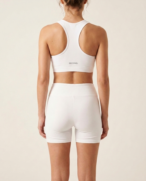 Back view of the SECOND. organic cotton set in white showing the SECOND. waistband, on a bone background