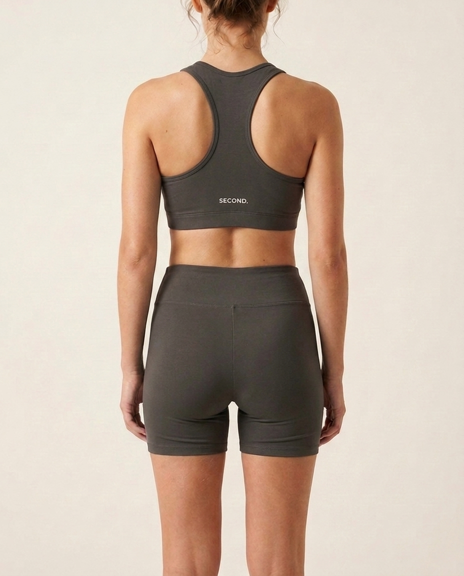 Back view of the SECOND. organic cotton set in white with the SECOND. waistband, on a bone background